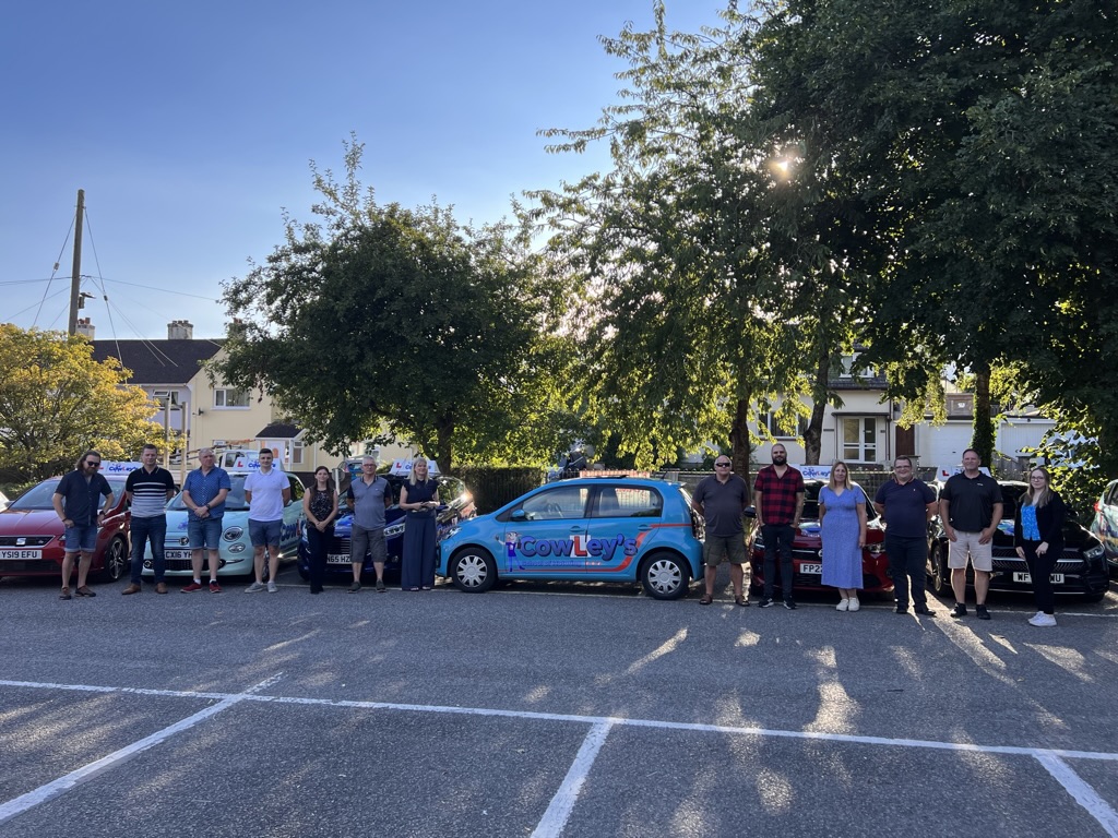 The Cowley's School of Motoring instructor team lined up with their branded tuition cars